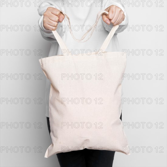 Woman standing and carrying a tote bag. Resolution and high quality beautiful photo