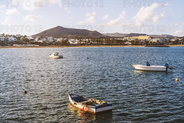 View of the resort town named Costa Teguise with boats on the foreground