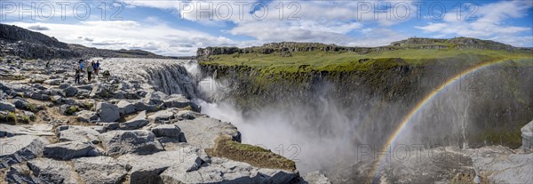 Canyon with falling water masses and rainbow