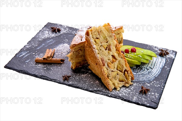 Apple pie on slate plate isolated on white