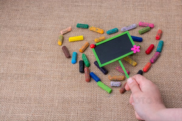 Notice board in the middle of crayons form a heart shape