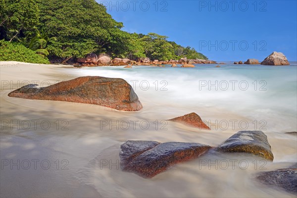 Beach and rocks of Anse Lazio in the evening