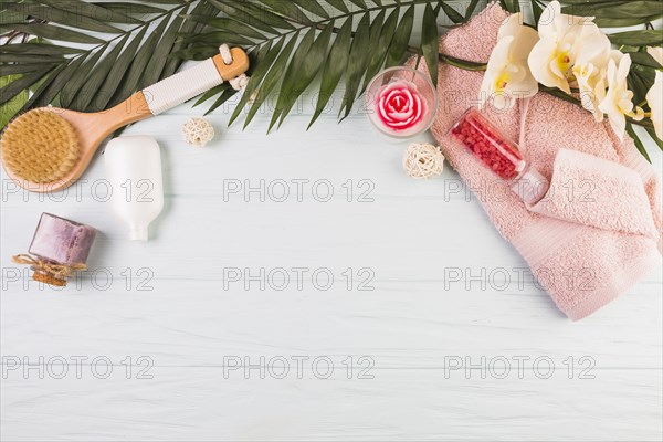 Towel salt bottle brush flowers leaves wooden background. Resolution and high quality beautiful photo