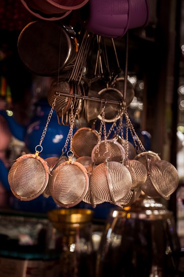 Group of metal strainers hanging in the view