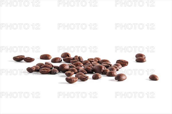 Coffee beans scattered on white background