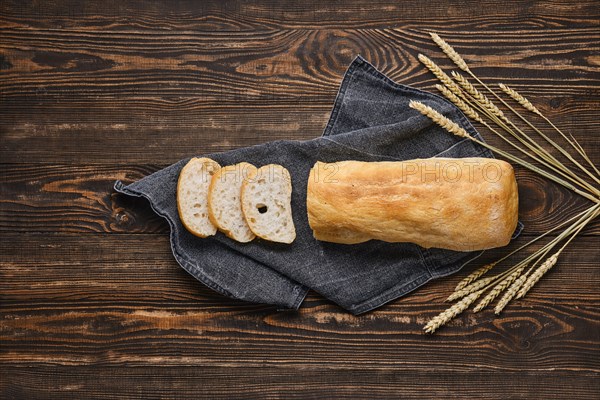 Freshly baked ciabatta on brown wooden table