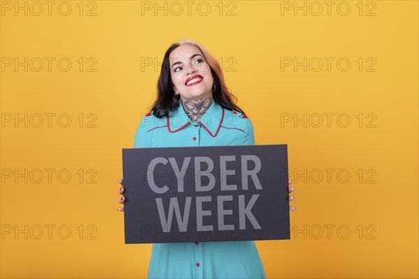 Beautiful woman holding a Cyber Week sign. Commercial concept. e- Commerce