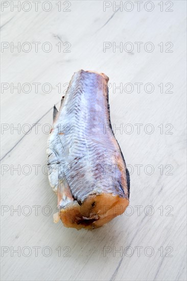 Frozen raw pollock carcass on wooden background