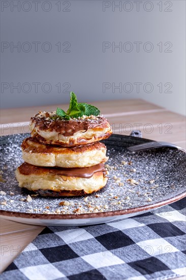 Fritters with peanut butter. Traditional Slavic pancakes with chocolate paste