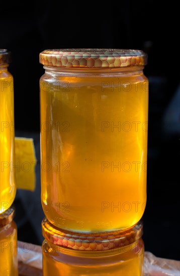 Glass jar of full of fresh honey with lid