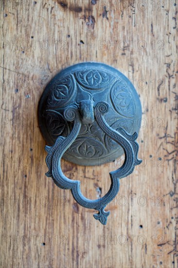 Old Handmade ottoman door knob on wood