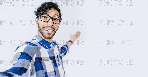 Man pointing back and presenting a product