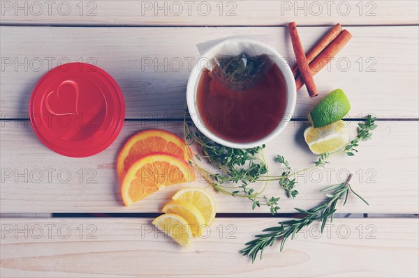 Top view of table with herb tea with orange