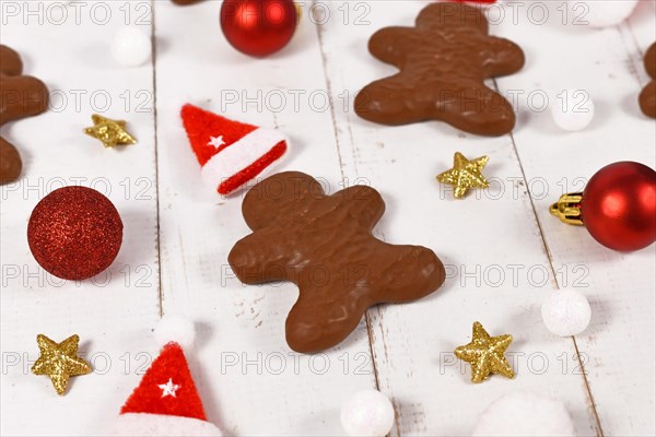 German gingerbread in shape of men glazed with chocolate between Christmas decoration
