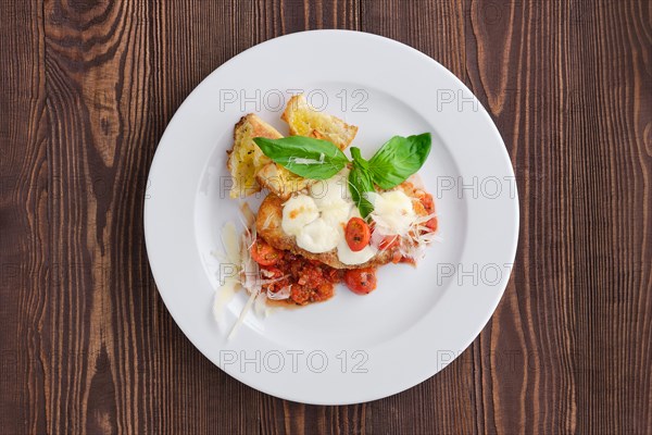 Top view of roasted chicken fillet with tomato cherry