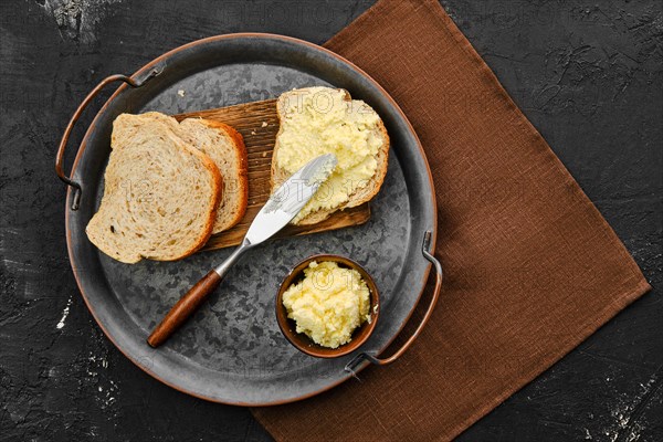 Top view of plate with homemade soft cheese spreaded on bread