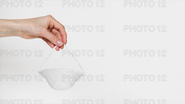 Close up hand holding mask