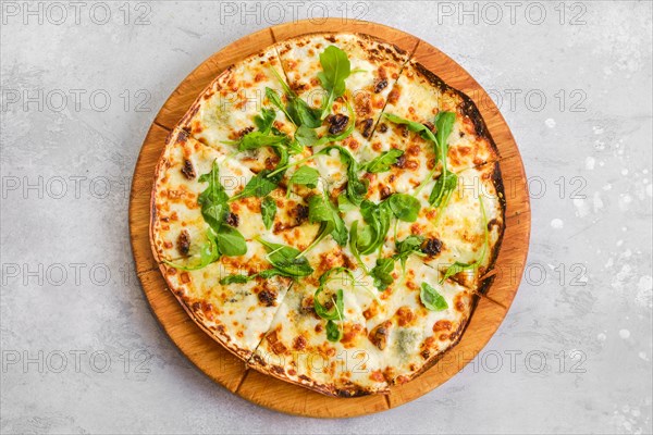 Top view of thin-crust pizza dough with walnuts