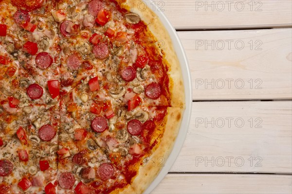 Top view of pizza pepperoni on wooden table