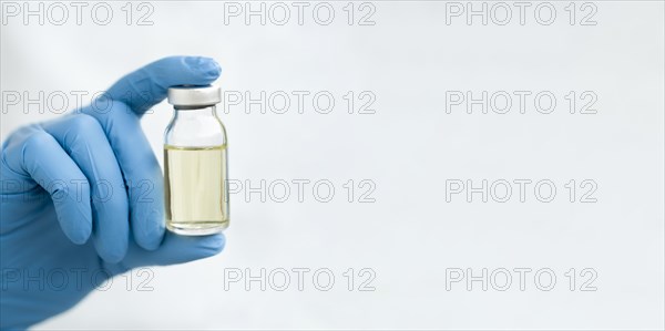 Front view doctor hand holding vaccine with copy space