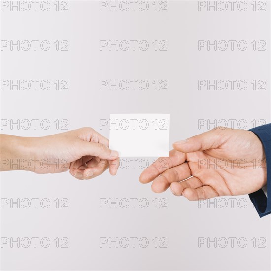 Hands exchanging business card