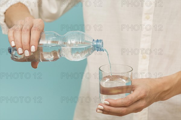 Woman pouring water into glass. Resolution and high quality beautiful photo
