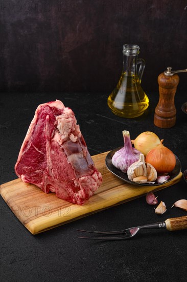 Raw porterhouse steak with spice and seasoning ready for cooking