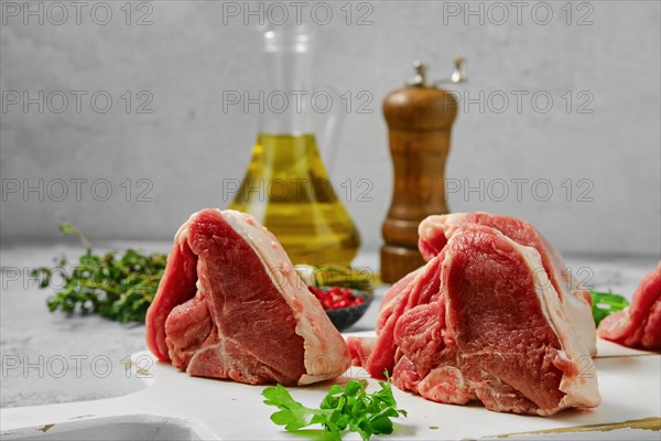 Uncooked boneless rack of lamb on cutting board