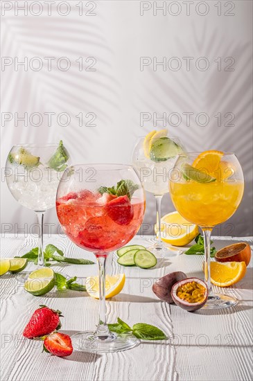 Cold sangria in wine glasses on white wooden table in morning sunlight