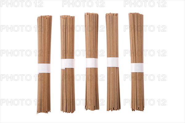 Dry soba buckwheat noodles isolated on white background