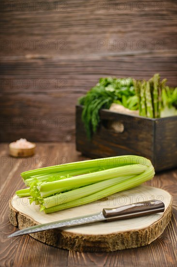 Fresh celery on wooden cutting board