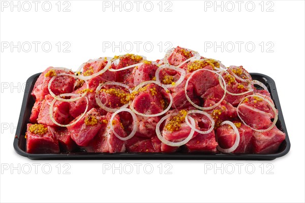 Tray with marinated meat cutted on pieces and ready for shashlik or kebab isolated on white