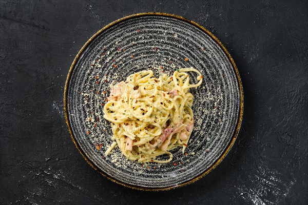 Overhead view of pasta with bacon and ham