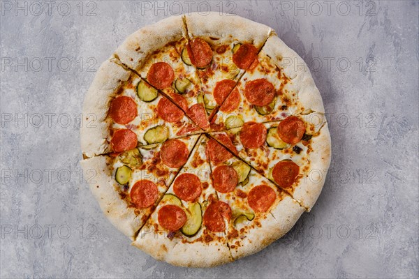 Top view of pizza pepperoni with cheese crust on wooden table