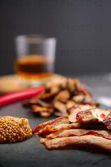 Soft focus photo of fried fillet with mushrooms and slices of bacon