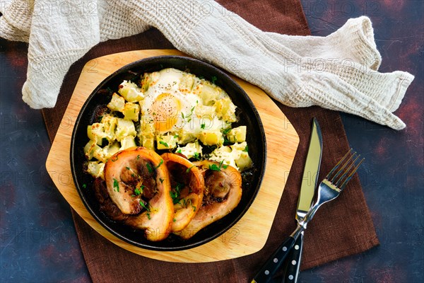 Top view of slised knuckle with fried potato and egg