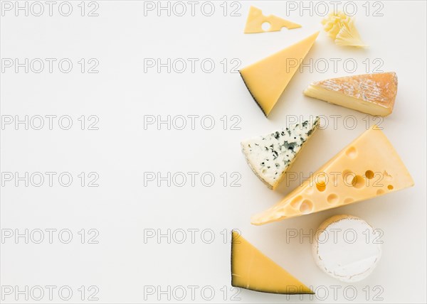 Flat lay assortment gourmet cheese with copy space