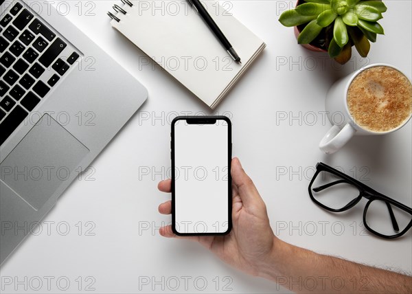 Flat lay desk with phone hand