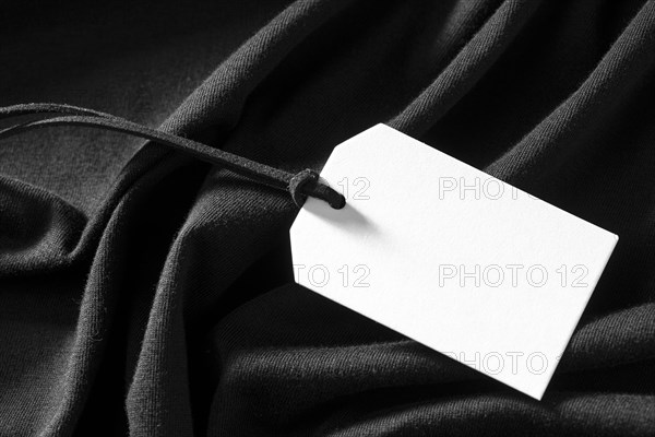 White empty label on black cloth. Resolution and high quality beautiful photo