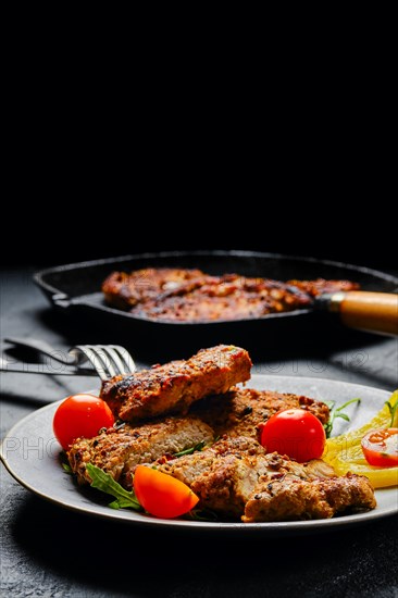 Pork chop fillet baked in oven with seasoning and herbs