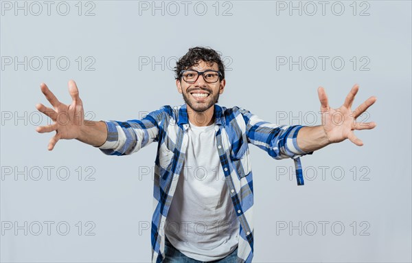 Man welcoming with open arms isolated. Friendly person welcoming. Generous young man with open arms isolated