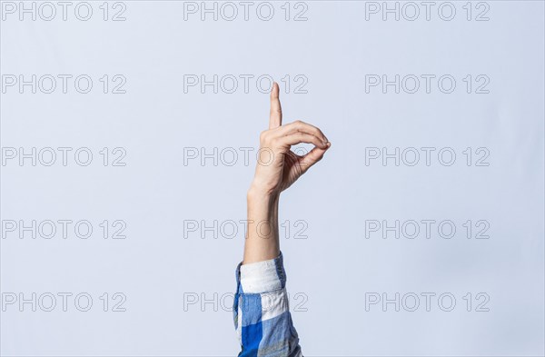 Hand gesturing the letter D in sign language on isolated background. Man hand gesturing the letter D of the alphabet isolated. Letters of the alphabet in sign language