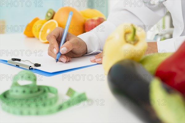 Close up nutritionist writing prescription