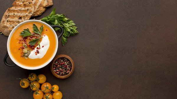 Flat lay winter squash soup bowl with toast copy space