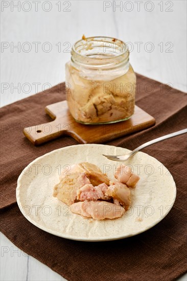 Canned cod liver in glass pot on the table