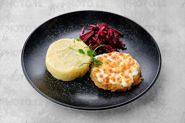 Kiev citlet with mashed potato and pickled beetroot on a plate