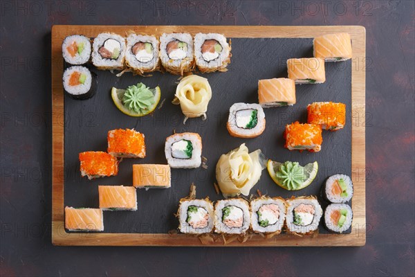 Top view of big set of rolls served on stone plate