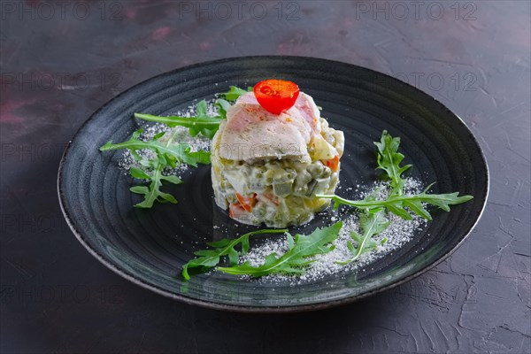 Olivier salad with slices of turkey