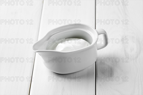 Sour cream in ceramic gravy boat