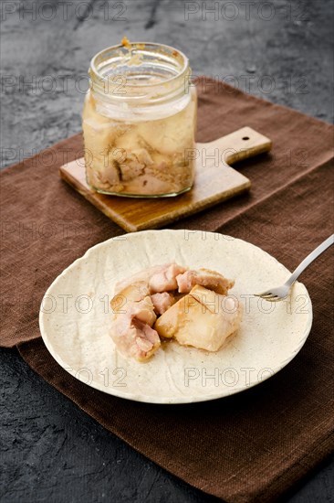 Canned cod liver in glass pot on the table